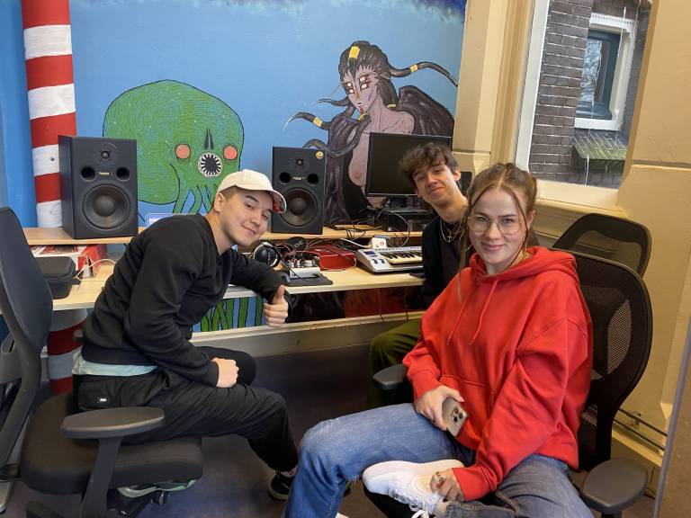 Three people in a music studio