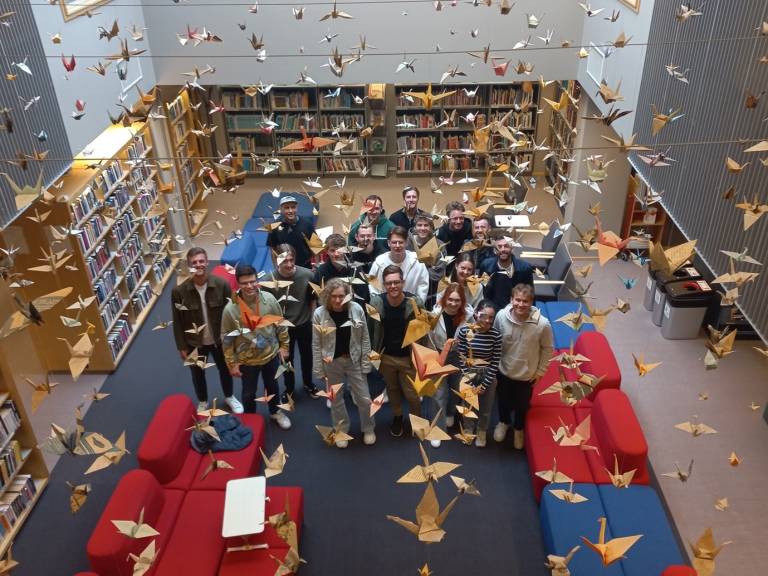 A group of people looking up in the library.